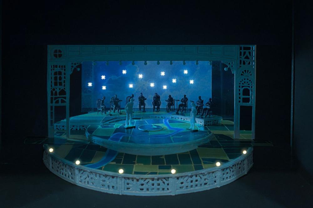 Image of The Music Man set model lit by hung blue star lights