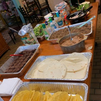 Ground beef, shredded roti chicken, vegetarian refried beans, lettuce and other toppings, brownies, and salad