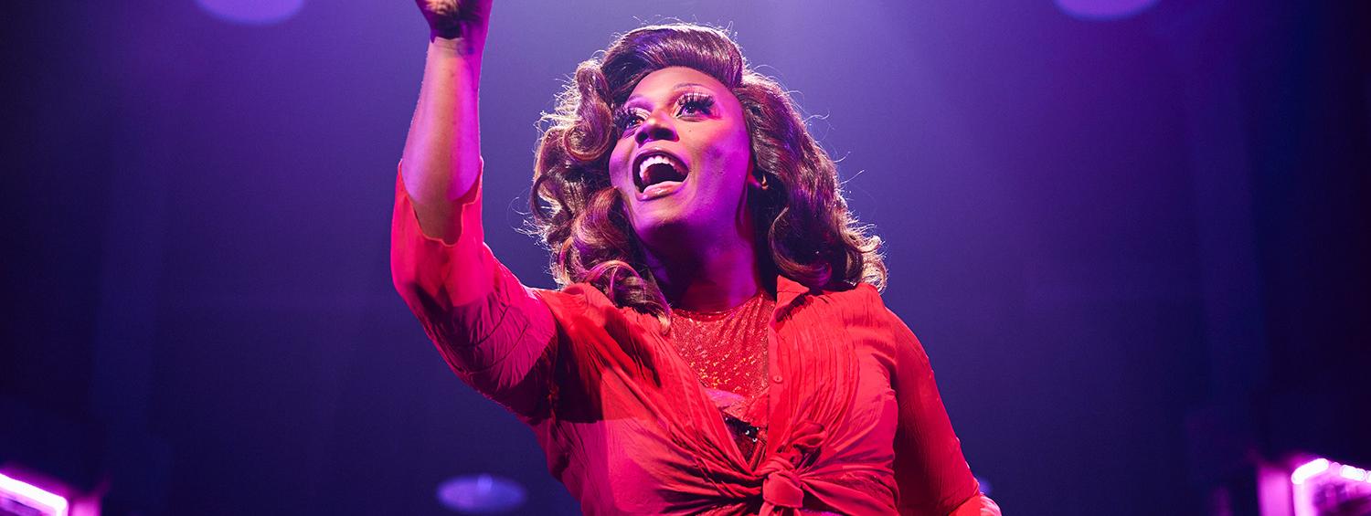 Solomon Parker as Lola in Olney Theatre Center's Kinky Boots. Image: Lola in a red dress